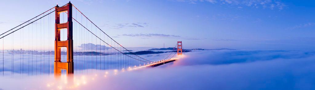 The Golden Gate bridge in San Francisco surrounded by fog at twilight, USA.