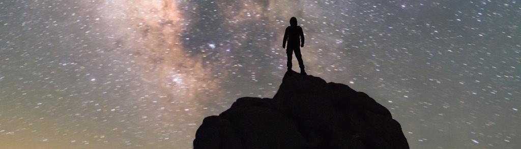 Milky Way. Night sky and silhouette of a standing man