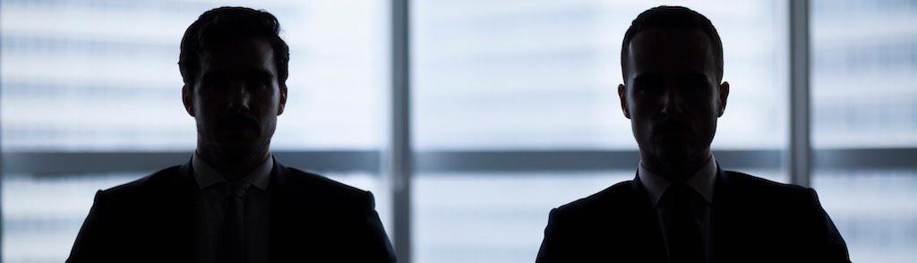 Silhouette pair of businessmen in meeting room